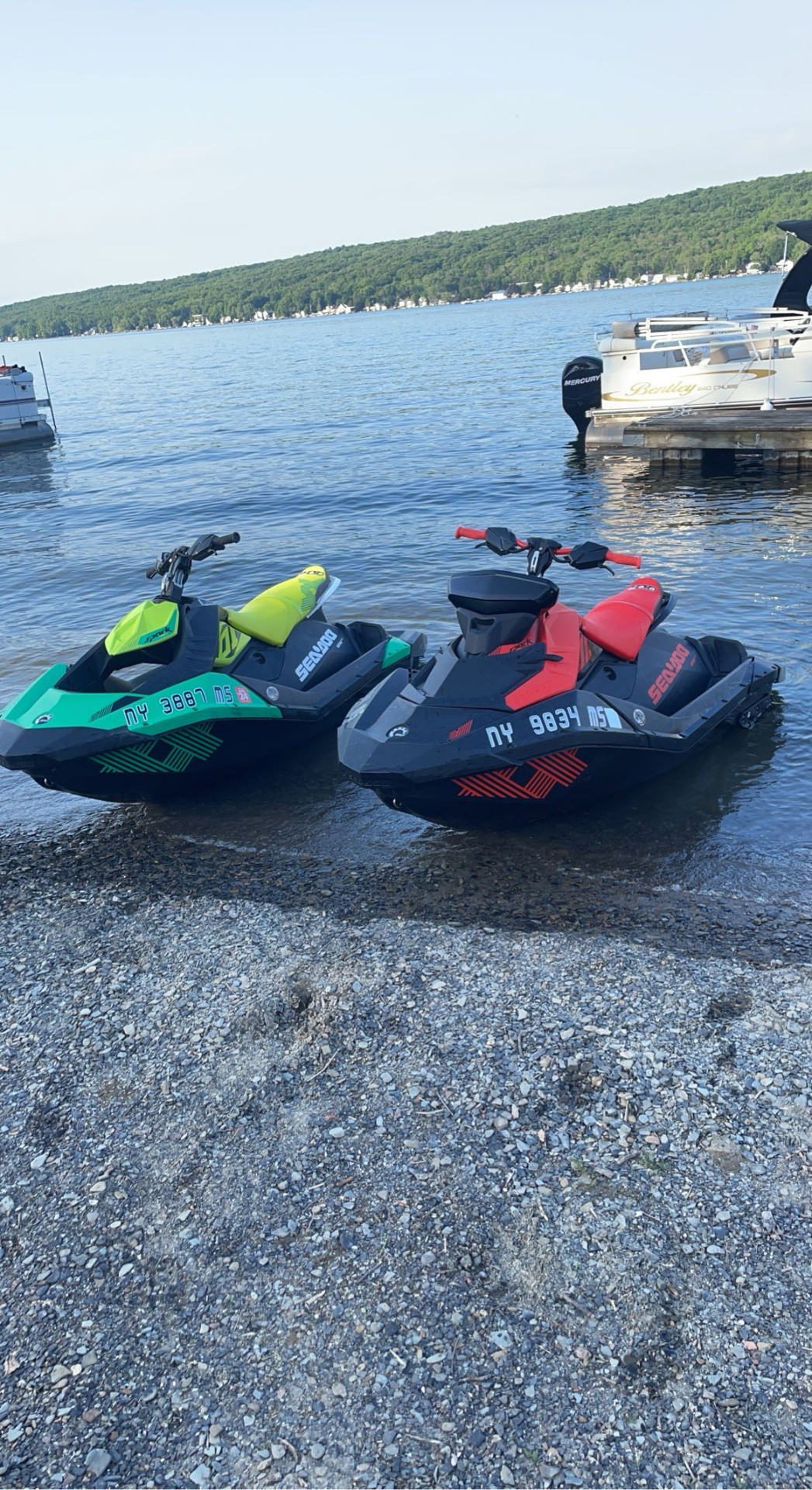 Two Sea-Doo Spark jet skis on the shore